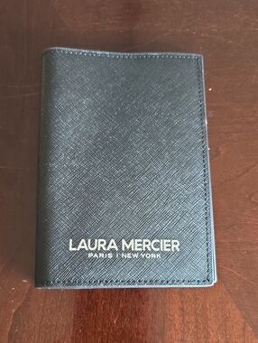 *NWOT*laura mercier Black textured Passport Holder with gold writing